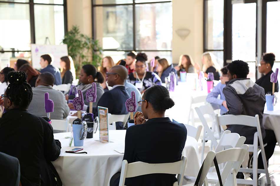 people gathered at an alumni event