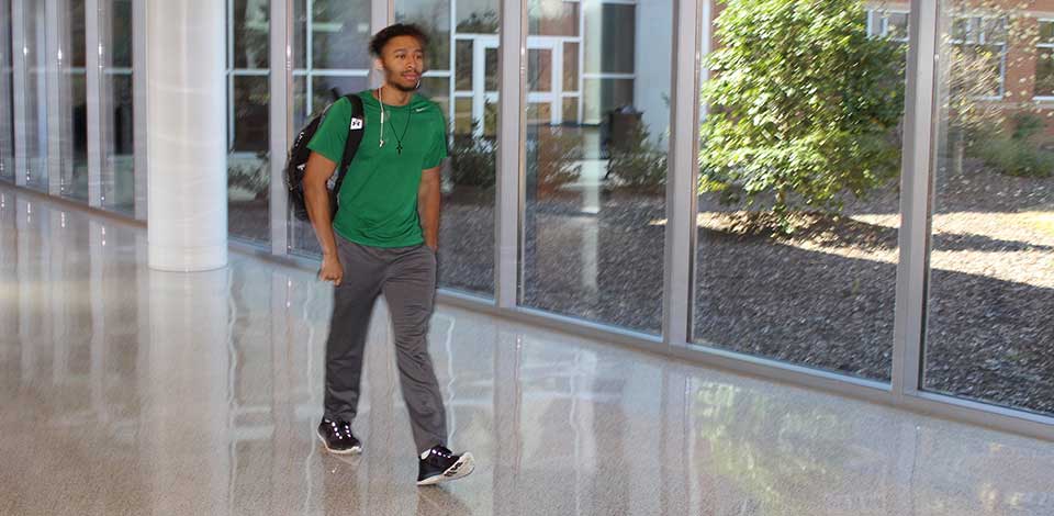 Student walking down a hall