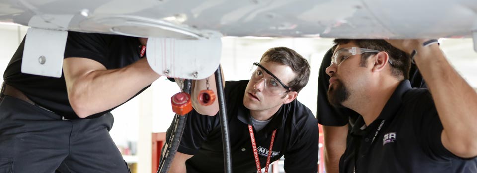 Students learning aircraft maintenance