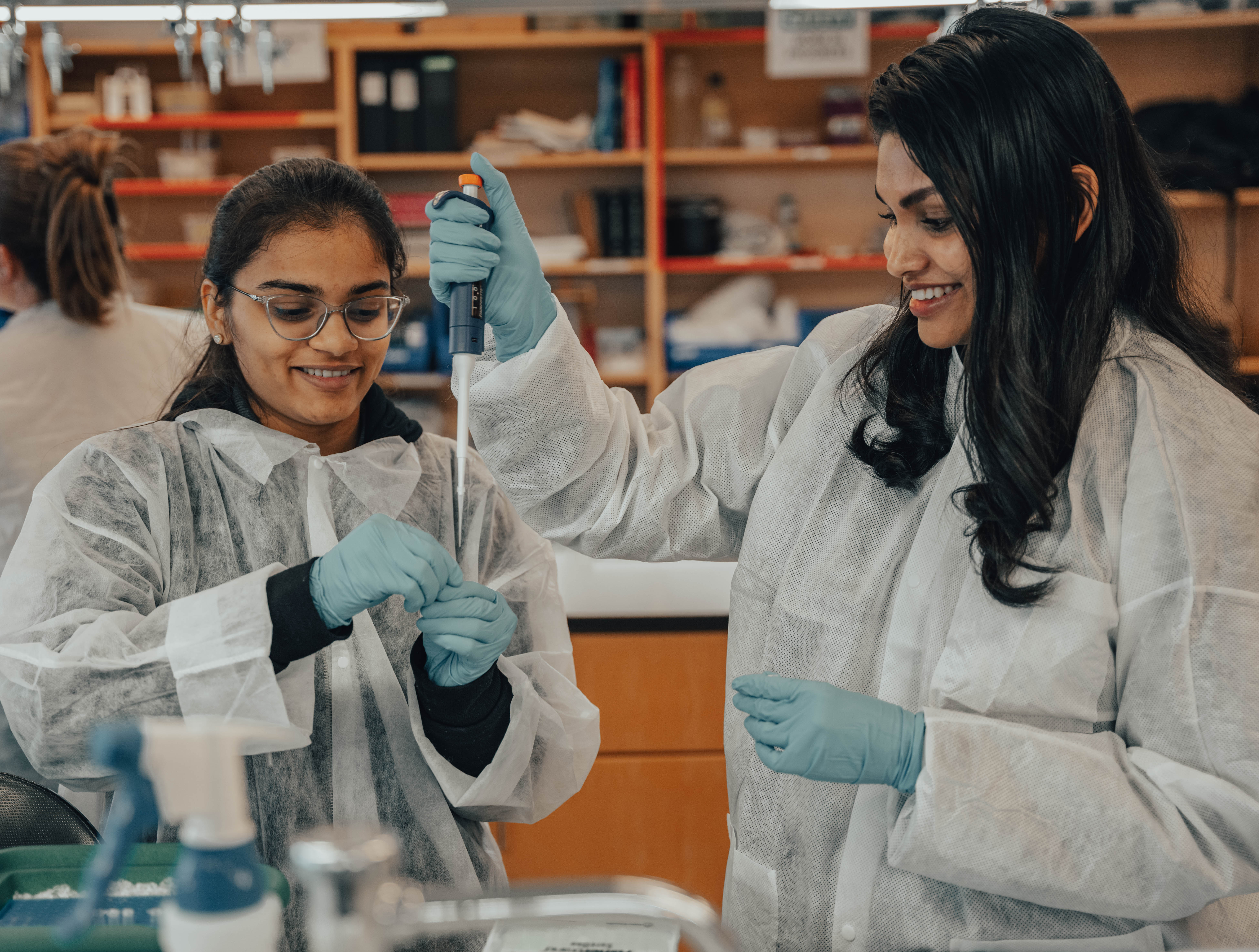 Molecular biology lab students pipetting