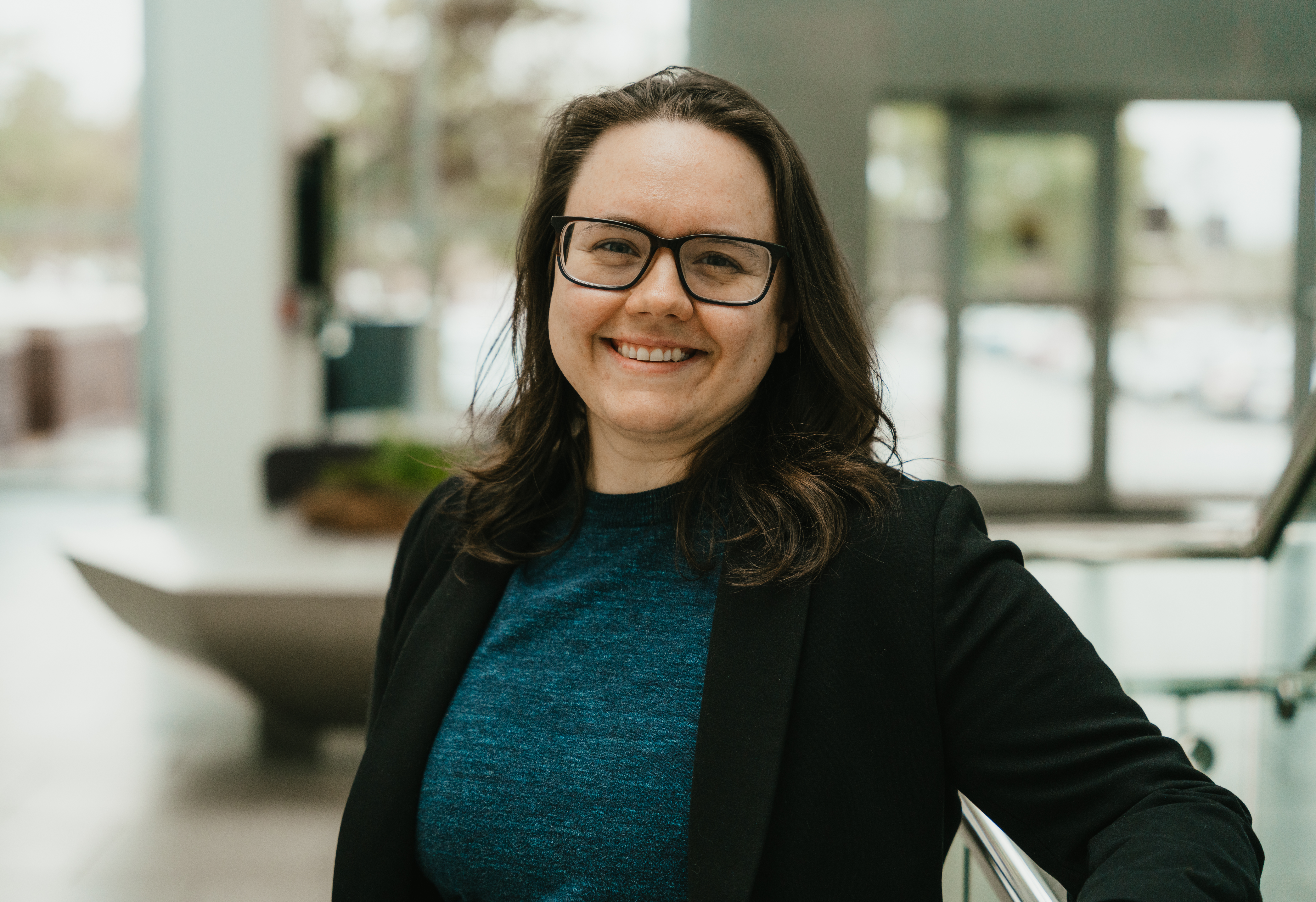 A picture of Dr. Heather Ness-Maddox in the lobby of the Jones Building